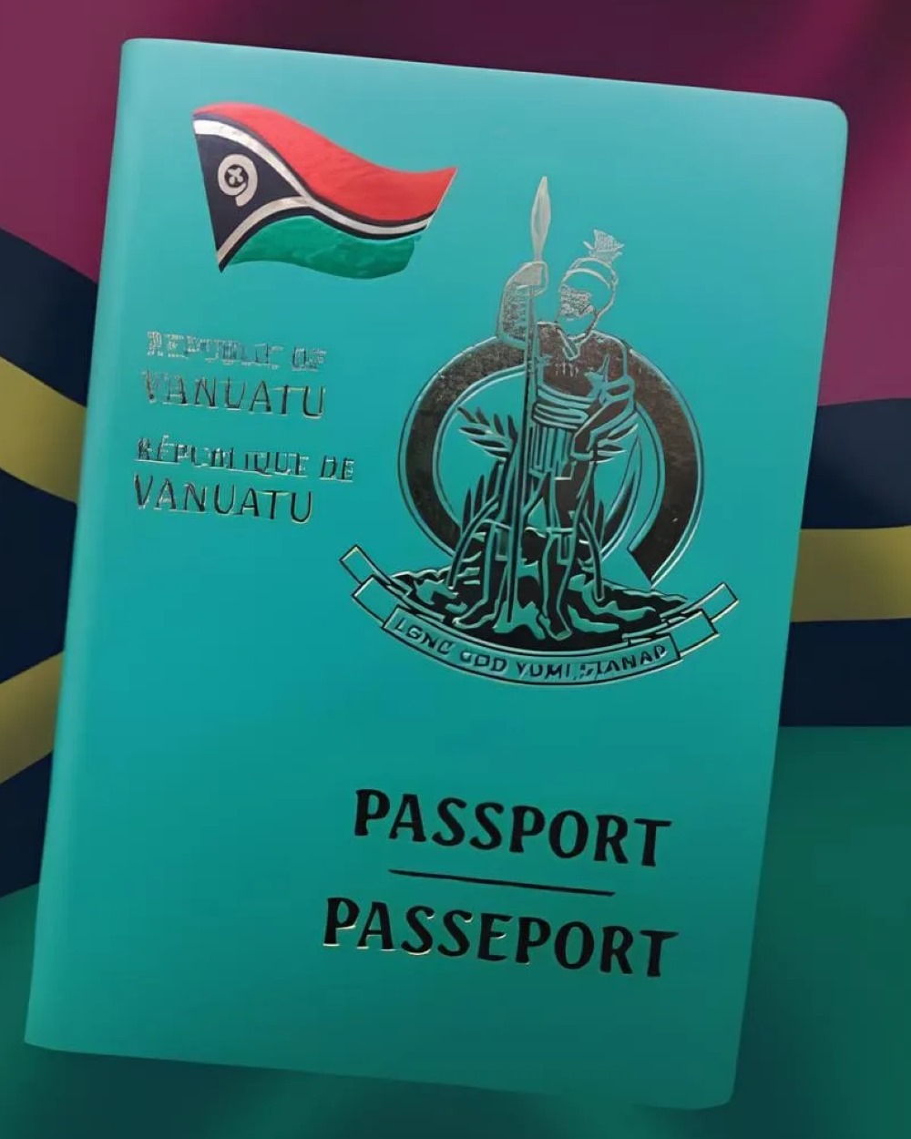 A Vanuatu passport, teal cover with a gold embossed coat of arms